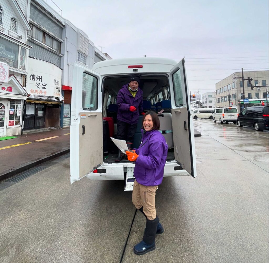 Nagano Snow Shuttle staff waiting to load luggage